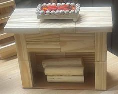 a wooden table topped with a tray of donuts on top of it's side