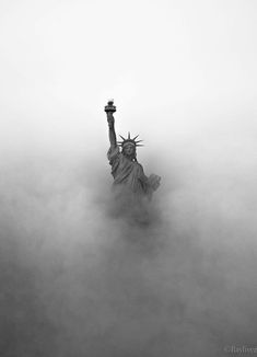 the statue of liberty is surrounded by fog