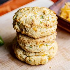 three biscuits stacked on top of each other next to a bowl of macaroni and cheese