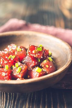 a wooden bowl filled with cooked food on top of a table stock photo - 9579