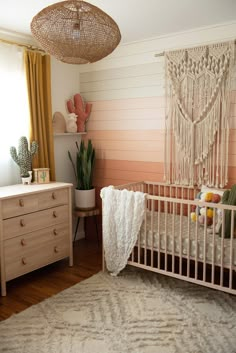 a baby's room with a crib and dresser