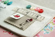 several different pictures of sewing supplies and buttons on a piece of fabric, with text overlaying the image