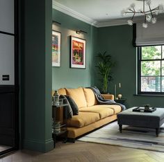 a living room with green walls and furniture