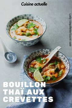 two bowls filled with soup and garnished with limes, cilantro