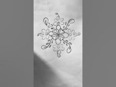 a black and white photo of a snowflake