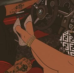 a woman's hand on the steering wheel of a car, with tattoos on her arm