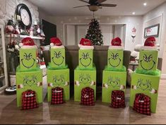 christmas presents are wrapped in green paper and have faces drawn on the boxes with santa hats