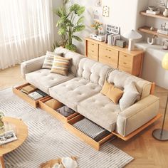 a living room filled with furniture and lots of pillows on top of a wooden floor