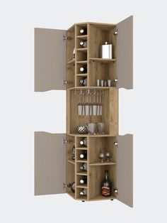 an open cabinet with bottles and glasses on it's shelves in front of a wall