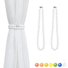 the white beaded necklace and earrings are next to an open curtain with beads on it