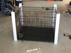 a dog cage sitting in the middle of a garage