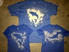 three t - shirts that have been made to look like dolphins in the ocean with white sprinkles on them