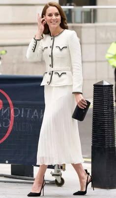 a woman in a white dress and black heels