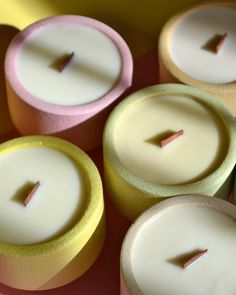 several different colored candles sitting on top of each other