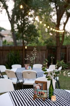 an outdoor wedding reception set up with striped tablecloths