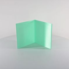 an open green folder sitting on top of a white table