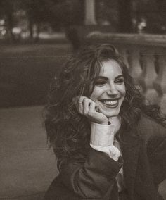 a black and white photo of a smiling woman