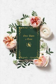 an open book surrounded by flowers on a white background with the words once upon a lime