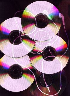 several cds are stacked on top of each other in the shape of an abstract design