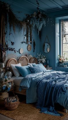 a bedroom with blue walls, wicker furniture and plants hanging on the wall above the bed