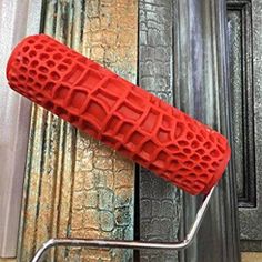 a close up of a red object on a metal rack in front of a door