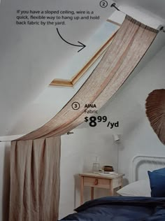 a bedroom with a bed and curtains on the ceiling, next to a window that has been pulled open