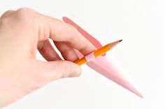 a person holding a pencil in their left hand and pointing it at the other side