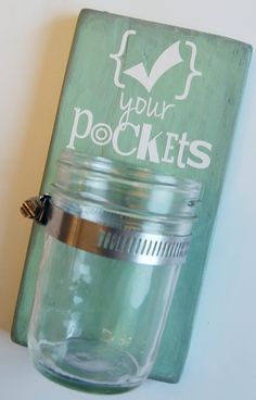 a mason jar hanging on the wall next to a sign that says your pooches