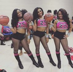 three cheerleaders are holding basketballs and posing for the camera