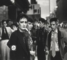 black and white photograph of people walking down the street