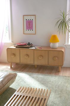 a living room with a couch, coffee table and potted plant