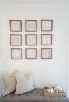 a bench with pillows and pictures on the wall