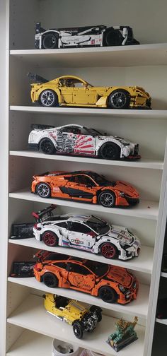 several toy cars are lined up on shelves