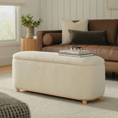 a living room scene with focus on the footstool and the glasses on the ottoman