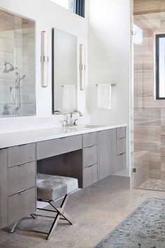 a large bathroom with two sinks and mirrors