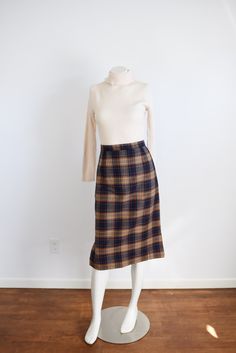 "Description: A navy and brown plaid pencil skirt with back metal zipper and snaps for closure. Unlined.  Measurements of garment, allow space for fit.  Waist: 25.5\" Hips: 38\" Length: 28\" I take my measurements flat, and double for circumference.  Tag: No tag, looks handmade. Fabric: Wool or blend Condition: Excellent Follow along on instagram @lovecharlesvintage"