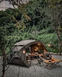 a tent set up in the middle of a forest