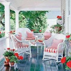 the porch is decorated with red and white furniture