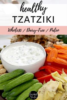 a platter with vegetables and dip on it that says healthy tzatziki