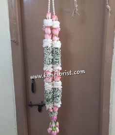 the door is decorated with pink and white flowers