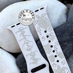 two apple watch bands sitting on top of rocks next to each other with the words, ocean and turtle designs printed on them