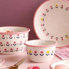 pink and white dishes with flowers on them