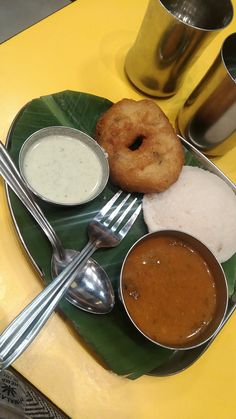 a plate topped with different types of food on top of a green leafy plate