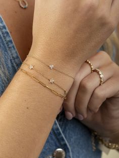 LeMel is known for its dainty gold jewelry! This dainty diamond star bracelet is the perfect addition to any bracelet stack! Layer it with a paperclip chain bracelet or make a statement with some tennis jewelry! Bracelet Stack Tennis Bracelet, Luxury Minimalist Diamond Chain Bracelet, Paperclip Bracelet Stack, Bracelet Stack Dainty, 14k Gold Dainty Bracelet With Star Charm, Dainty 14k Gold Bracelet With Star Charm, Dainty Star-shaped Bracelets For Everyday Wear, Elegant Everyday Bracelets With Star Charm, Diamond Paperclip Chain Bracelet