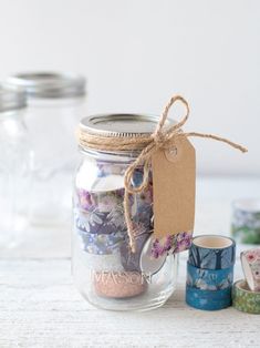 there is a jar with some things in it and a tag hanging from the top