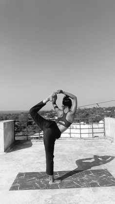 a woman is doing yoga outside in the sun