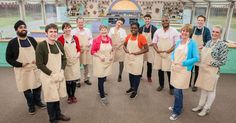 a group of people in aprons standing together