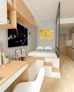 a bedroom with a bed, desk, and television in the corner next to it