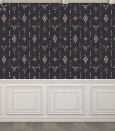 an empty room with black wallpaper and white paneled walls, decorated with decorative designs