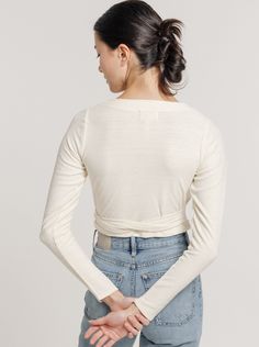 The estimated shipping window on all resort pre-orders is 1/15/24 - 2/1/24. Crafted from eco-conscious textured silk noil, this garment embodies sustainable fashion by repurposing leftover silk filaments into a new, distinctive strand. The result is a luxuriously soft and velvety slub texture that's truly one-of-a-kind. Due to the nature of this unique fabrication, each piece is distinct, and variations in shade and sizing of up to 1" in length and width are to be expected. Experience both style Ballet Wrap Top, Silk Noil, Tailored Skirt, The Ballet, Indian Textiles, Ivory Silk, Eco Conscious, Wrap Top, Raw Silk